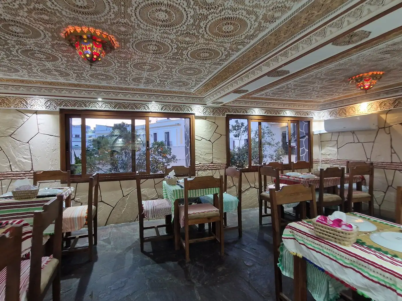 Salle à l'étage de Maison Grill Kasbah avec grandes fenêtres et plafond sculpté